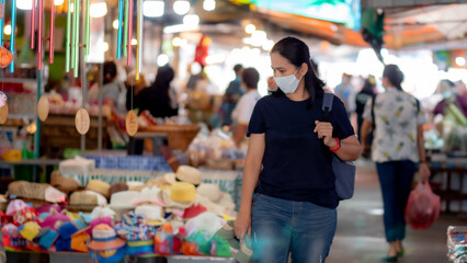 Portrait of Asia woman wearing mask shopping in the fresh market