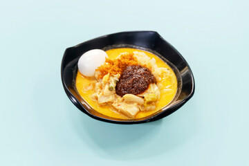 Close up of a bowl of lontong on a table