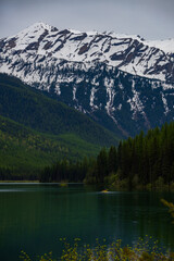 Fototapeta premium Kayaker on Stanton Lake and Great Northern Mountain, Montana