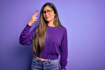 Young beautiful smart woman wearing glasses over purple isolated background Shooting and killing...