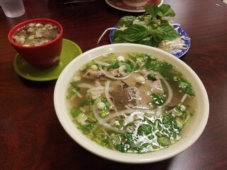 large bowl of Vietnamese beef soup with vegetables