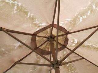 damaged and worn umbrella for a table