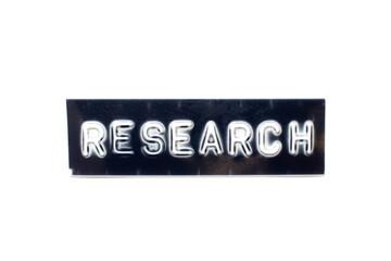 Embossed letter in word research in black banner on white background
