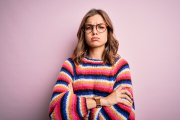 Young beautiful blonde girl wearing glasses and casual sweater over pink isolated background...