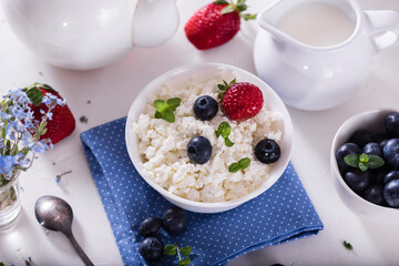 healthy breakfast cottage cheese in white bowl with fresh summer  berries