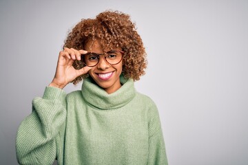 African american optical woman with curly hair wearing glasses over isolated white background with a happy face standing and smiling with a confident smile showing teeth