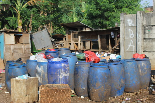 Jakarta, Indonesia - 06082020: Temporary residents' garbage shelter. Blue barrel to store trash. Trash clinic and household trash.
