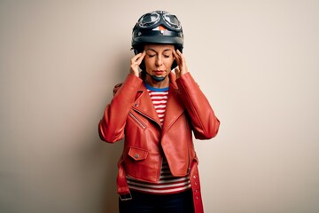 Middle age motorcyclist woman wearing motorcycle helmet and jacket over white background with hand on head for pain in head because stress. Suffering migraine.