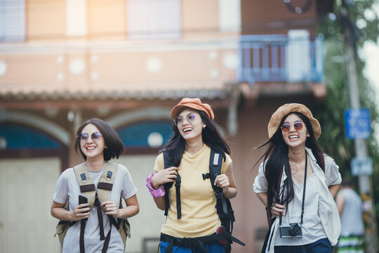 Asian Woman Group Backpacker Travel On Street Together, Friendship Traveller Backpack Travel For New Experience.
Asian Girl Team Traveling Thailand Trip.