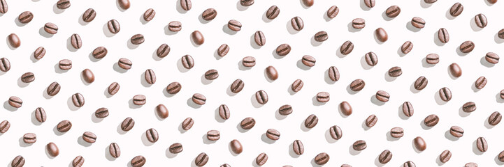 Many coffee beans at white background. Isolated pattern seeds. Roast arabica restaurant concept. Taste energy brown morning beverage. Cafe wallpaper. Horizontal banner. Hard shadows
