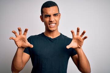 Young handsome african american man wearing casual t-shirt standing over white background smiling...