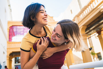 Loving lesbian couple having fun at the street.