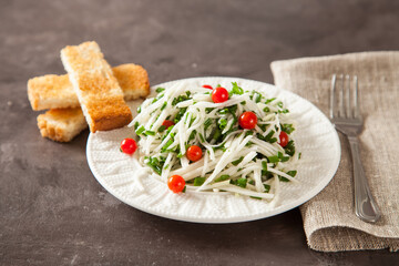 salad from a kohlrabi with green onions, selective focus