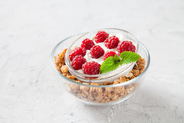 muesli, cottage cheese and raspberry in a bowl on a table, selective focus
