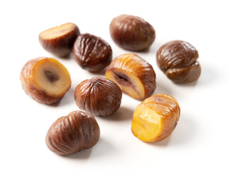 Peeled sweet chestnuts on a white background