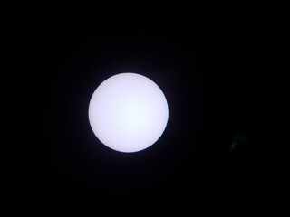 the sun and sunspots viewed through a solar filter on a telescope