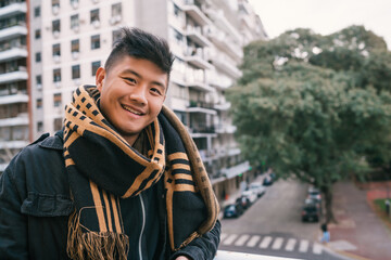 Portrait of young Asian man outdoors.