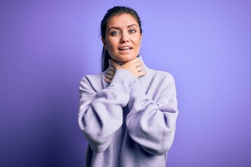 Young beautiful woman with blue eyes wearing casual turtleneck sweater over pink background shouting and suffocate because painful strangle. Health problem. Asphyxiate and suicide concept.