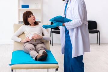 Injured young woman visiting young male doctor