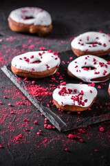 Freshly baked glazed donut with raspberry