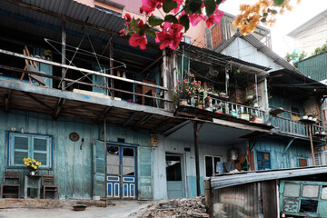 old downgrade residence area on slopes, ancient wooden house in cyan at Da Lat, Vietnam
