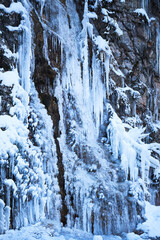 Icicles on the rock. Frozen waterfall in winter.