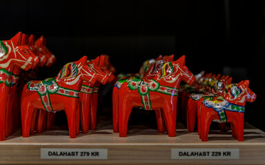Traditional hand-made carved and painted dalarna wooden horse souvenir at a souvenir shop in Stockholm, Sweden