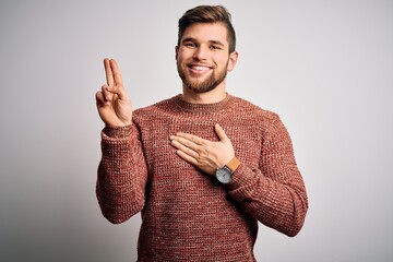Young blond man with beard and blue eyes wearing casual sweater over white background smiling...