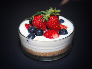 Healthy bowl of fresh strawberry and blueberry with yogurt and biscuit