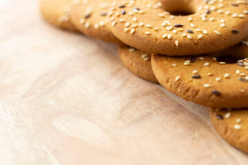 Round cookies with sesame seeds on a wooden background. Copy space