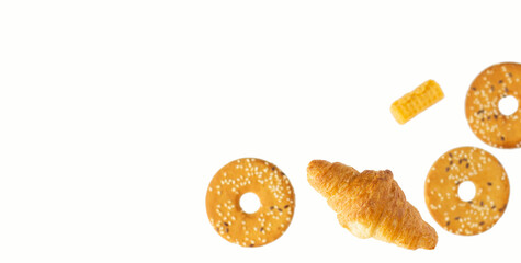 Various sweets. Croissants, cookies and waffles flying on a white background