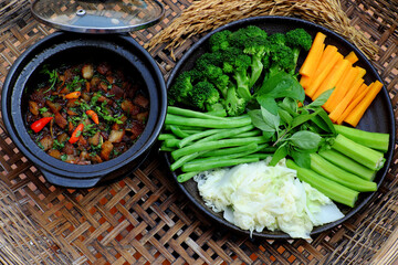 Vietnamese meal for vegetarian, plate of boiled vegetables, vegan braised sauce in pot with rice