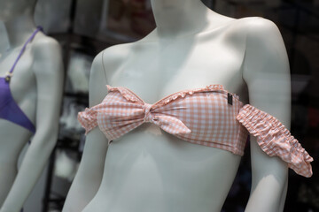 closeup of pink bikini on mannequin in fashion store showroom for women