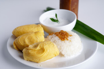 'Pulut Durian' is a glutinous or sticky rice with durian, coconut milk and sprinkle of grated palm sugar popuar food in Malaysia, Thailand and Indonesia -selective focus
