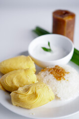 'Pulut Durian' is a glutinous or sticky rice with durian, coconut milk and sprinkle of grated palm sugar popuar food in Malaysia, Thailand and Indonesia -selective focus
