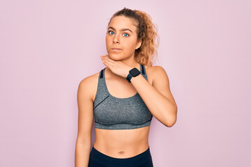 Young beautiful blonde sportswoman with blue eyes doing exercise wearing sportswear cutting throat with hand as knife, threaten aggression with furious violence