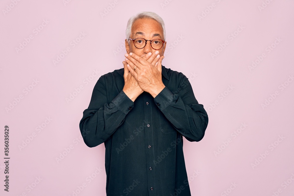 Sticker middle age senior grey-haired handsome man wearing glasses and elegant shirt shocked covering mouth 