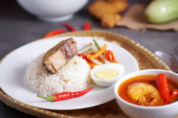 "Nasi Dagang" a popular Malaysian meal especially east coast of the Malaysian Terengganu and Kelantan. It consists of rice steamed in coconut milk, fish curry, hard boiled eggs and pickled vegetables