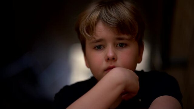 Portrait of a thoughtful, serious, short-haired little girl. A rather sad child has disappeared