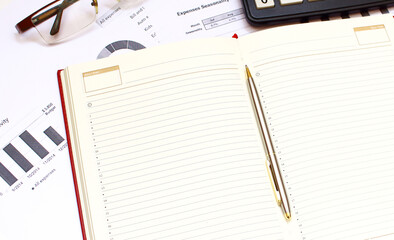 A notebook lies among the financial statements. office desk.