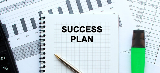 A notebook lies among the financial statements on the office desk. In the notebook, the inscription. calculator