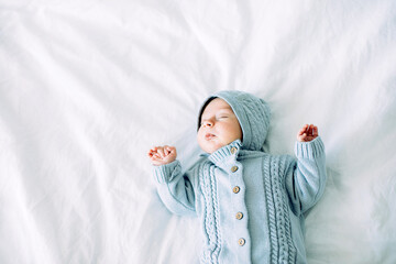 Month old newborn baby boy in bed. Children sleep. Infant napping in bed. Top view, place fot text