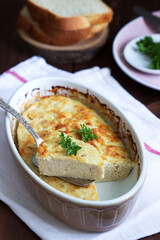 Dietary souffle of minced meat with parsley on a dark background.
