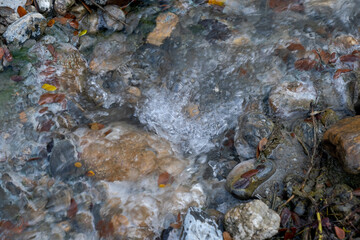 Hot spring water flowing on the rock in a morning