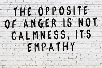 Black painted inscription of smart quote on white brick wall