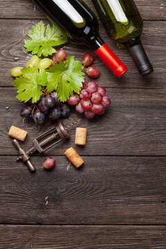 Various grapes, wine bottles and corkscrew