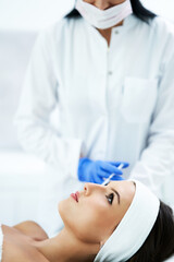 Naklejka premium Beautiful young woman getting face treatment at beauty salon.