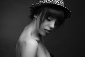 black and white brunette in a hat with off the shoulder neckline.