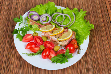 Baked ocean perch with vegetables on dish on table mat