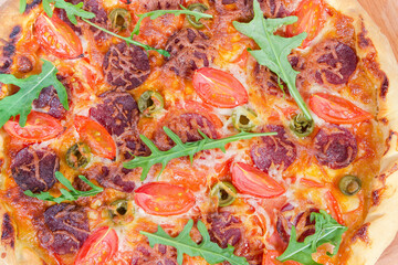 Background of pizza with sausage and cherry tomatoes, top view